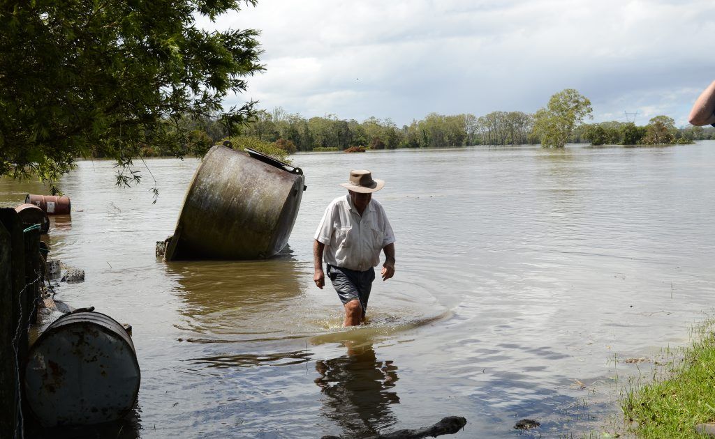 Local Coutts Crossing farmer Dennis Reilly checks on an old molasses tin during flooding on Saturday. Photo Debrah Novak / The Daily Examiner Local Coutts Crossing farmer Dennis Reilly checks on an old molasses tin during flooding on Saturday. Photo Debrah Novak / The Daily Examiner